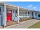 Charming ranch home with a red door, gray exterior, and walkway at 2127 Lake Dr, Winter Park, FL 32789