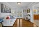 Cozy living room with hardwood floors, a white couch, and French doors leading to backyard at 2127 Lake Dr, Winter Park, FL 32789