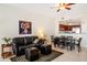 Living room with black leather sofa and dining area at 225 W Seminole Blvd # 412, Sanford, FL 32771