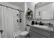 Clean bathroom with shower, vanity, and floating shelves at 229 Gina Ln, Davenport, FL 33837