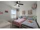 Charming bedroom with two twin beds, window, and wall decor at 229 Gina Ln, Davenport, FL 33837