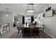 Farmhouse style dining area with a large wooden table and pendant lighting at 229 Gina Ln, Davenport, FL 33837