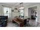 Dining room with rustic wooden table, bench seating, and an open floor plan at 229 Gina Ln, Davenport, FL 33837