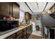 Galley kitchen with wood cabinets and modern appliances at 2536 Lemon Tree Ln, Orlando, FL 32839