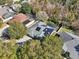 Aerial view showcasing house and neighborhood, highlighting solar panels at 2647 Aloma Oaks Dr, Oviedo, FL 32765