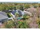 Aerial view of house, pool, and surrounding landscape at 2647 Aloma Oaks Dr, Oviedo, FL 32765