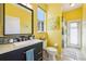 Bright bathroom with walk-in shower, modern vanity, and yellow walls at 2647 Aloma Oaks Dr, Oviedo, FL 32765