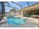 Inviting screened pool area with patio furniture and lush landscaping at 2647 Aloma Oaks Dr, Oviedo, FL 32765