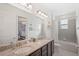 Double vanity bathroom with granite countertops and a bathtub at 266 Southfield St, Kissimmee, FL 34747