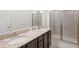 Elegant bathroom with double sinks, granite countertop, and a large shower at 266 Southfield St, Kissimmee, FL 34747