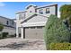 Two-story house with gray siding, brown garage door, and a paved driveway at 266 Southfield St, Kissimmee, FL 34747