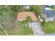 Aerial view of single-story house with a brown roof and palm trees at 2661 Ames Haven Rd, Kissimmee, FL 34744