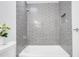 Updated bathroom with gray tile shower and bathtub at 2661 Ames Haven Rd, Kissimmee, FL 34744