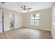 Spacious bedroom with ceiling fan, large window, and new flooring at 2661 Ames Haven Rd, Kissimmee, FL 34744