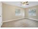 Well-lit bedroom with ceiling fan and vinyl flooring at 2661 Ames Haven Rd, Kissimmee, FL 34744