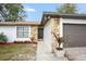 Front entrance with stone detailing and landscaping at 2661 Ames Haven Rd, Kissimmee, FL 34744