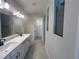 Bright bathroom featuring a double vanity, modern fixtures, and a glass-enclosed shower at 2753 Redblush Ter, St Cloud, FL 34772