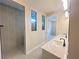 Bathroom featuring a double vanity, modern fixtures, and a glass-enclosed shower at 2753 Redblush Ter, St Cloud, FL 34772