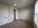 Bedroom features natural light, wood flooring and a closet with sliding doors at 2753 Redblush Ter, St Cloud, FL 34772