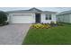 Charming single-story home with a well-manicured lawn and brick driveway at 2753 Redblush Ter, St Cloud, FL 34772