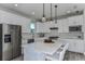 Stylish kitchen with a large island, stainless steel appliances, and modern backsplash at 2753 Redblush Ter, St Cloud, FL 34772