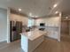 Modern kitchen featuring stainless steel appliances, a center island, and ample cabinet space at 2753 Redblush Ter, St Cloud, FL 34772