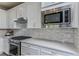 Elegant kitchen with stainless steel appliances, stylish backsplash, and gas range at 2753 Redblush Ter, St Cloud, FL 34772