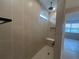 Modern tiled shower with a rainfall shower head, seating, and a built-in niche at 2753 Redblush Ter, St Cloud, FL 34772