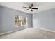 Bedroom with large window and ceiling fan at 2760 Curpin Ln, Orlando, FL 32825