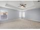 Spacious bedroom with tray ceiling and ceiling fan at 2760 Curpin Ln, Orlando, FL 32825