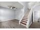 Living room with tiled floors and wooden staircase at 2760 Curpin Ln, Orlando, FL 32825