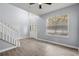 Bright living room with tiled floors, stairs, and a large window at 2760 Curpin Ln, Orlando, FL 32825