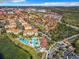 Aerial view of community with resort-style pool and surrounding buildings at 2821 Almaton Loop # 303, Kissimmee, FL 34747