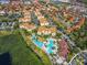 Aerial view of community showing pool, landscaping and residential buildings at 2821 Almaton Loop # 303, Kissimmee, FL 34747