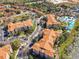 Aerial view of community with pool, parking and residential buildings at 2821 Almaton Loop # 303, Kissimmee, FL 34747