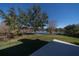 Deck overlooks fenced backyard with lake view at 3511 Exeter Ct, Orlando, FL 32812