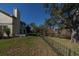 Home's back deck and fenced yard with lake view at 3511 Exeter Ct, Orlando, FL 32812