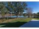 Deck overlooks fenced backyard with lake view at 3511 Exeter Ct, Orlando, FL 32812