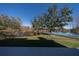 Lake view from a backyard deck with a wooden fence and lush landscaping at 3511 Exeter Ct, Orlando, FL 32812