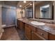 Double vanity bathroom with granite countertop and large mirrors at 3511 Exeter Ct, Orlando, FL 32812