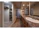 Double vanity bathroom with granite countertop and large mirrors at 3511 Exeter Ct, Orlando, FL 32812