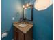 Small bathroom with granite countertop and teal walls at 3511 Exeter Ct, Orlando, FL 32812