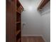 Walk-in closet with shelves and hanging rods at 3511 Exeter Ct, Orlando, FL 32812