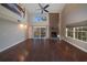 Living room with hardwood floors, fireplace, sliding glass doors, and large windows at 3511 Exeter Ct, Orlando, FL 32812