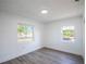 Spacious bedroom with large windows and wood-look floors at 355 E Hoffman St, Lake Alfred, FL 33850