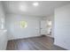 Bright bedroom with wood-look floors and two windows at 355 E Hoffman St, Lake Alfred, FL 33850