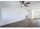 Spacious living room with hardwood floors and ceiling fan at 355 E Hoffman St, Lake Alfred, FL 33850