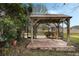 Relaxing patio with pergola and brick pavers, overlooking the pool area at 36737 Antone Dr, Grand Island, FL 32735