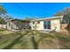 Backyard view of home with screened porch at 3710 Sutton Dr, Orlando, FL 32810