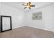 Spacious bedroom with ceiling fan and large mirror at 3710 Sutton Dr, Orlando, FL 32810